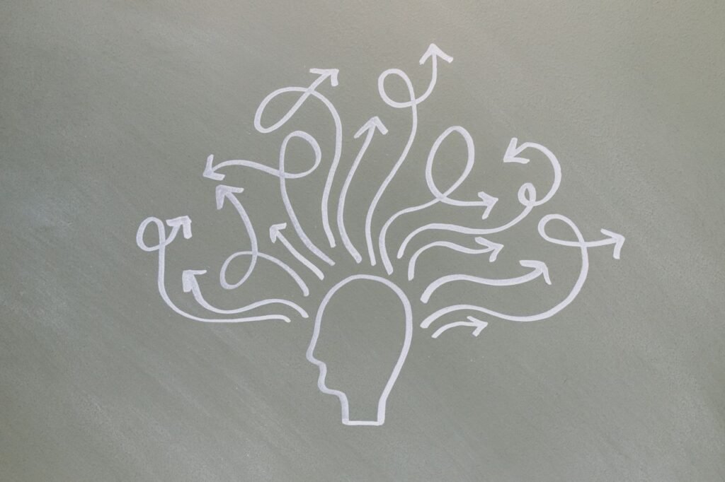Conceptual chalk drawing illustrating mental health challenges with arrows representing thoughts.